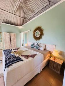 a bedroom with a large bed with a mirror on the wall at Soma Bloom Resort in Jembrana +31 photos