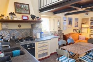 a kitchen with a stove and a table in a room at Exclusive Villa - Relax - A-C - Stunning View in Porto Ercole