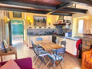 a kitchen with a wooden table and chairs at Exclusive Villa - Relax - A-C - Stunning View in Porto Ercole +34 photos