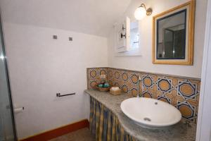 a bathroom with a sink and a mirror at Exclusive Villa - Relax - A-C - Stunning View in Porto Ercole