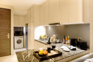 a kitchen with a counter with a tray of fruit on it at Ascott Waterplace Surabaya in Surabaya