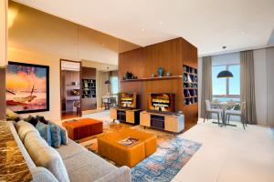 a living room with a couch and a table at Ascott Waterplace Surabaya in Surabaya +40 photos