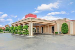 a building with a parking lot in front of it at Ramada by Wyndham Murfreesboro in Murfreesboro