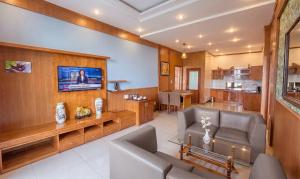 a living room with a couch and a tv at Lien Do Star Hotel in Bảo Lộc +61 photos