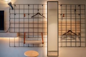 a room with a mirror and a wooden chair at Moxy Bordeaux in Bordeaux