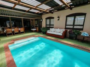 a swimming pool in a living room with a couch and a table at Merensee in Langebaan
