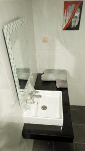 a bathroom with a white sink and a mirror at Villa de Gema in Selabintana +55 photos
