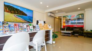 a store with white chairs and a large screen at Three Monkeys Chaweng Beach in Chaweng