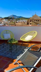 two chairs and a table on a balcony at CASA VERA, Casa completa para familias o grupos en el centro de Antequera in Antequera
