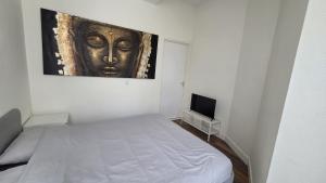 a bedroom with a bed and a painting on the wall at Perfectly Located, Surprisingly Quiet in Gouda