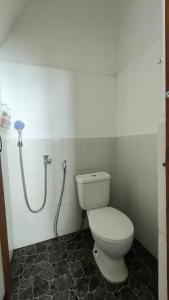 a bathroom with a toilet and a shower at Mentari Ocean View Resort in Tamperan