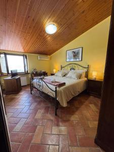 a bedroom with a bed and a wooden ceiling at Locanda del Castello in Frontone +19 photos