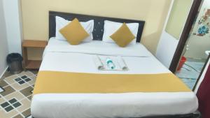 a hotel room with a bed with a book on it at The Urban Villa in Noida