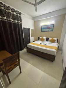 a bedroom with a bed and a chair in it at The Urban Villa in Noida