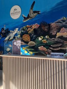 a display of an aquarium with fish and reefs at Sebastian Guest House in Moalboal