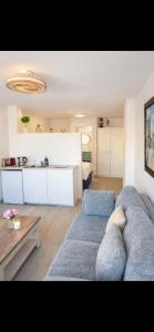 a living room with two blue couches and a table at Beachfront Studio in Castillo de la Duquesa in Castillo de Sabinillas