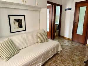 a living room with a couch in a room with at RioRooms La Valletta Riomaggiore Center in Riomaggiore