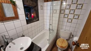 a bathroom with a toilet and a sink and a shower at Casa da Serreta by PontaNegraAzores in Serreta +51 photos