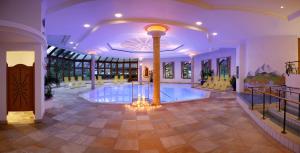 a large room with a swimming pool in a house at Alpenresidenz-Sonnwend - Wellness Apartments nahe Zillertal Arena in Zell am Ziller