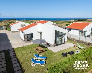 an aerial view of a house with chairs and a table at Bird House by PontaNegraAzores in Altares