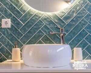 a white sink in a bathroom with a mirror at Bird House by PontaNegraAzores in Altares +18 photos