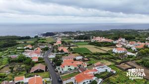 an aerial view of a town with houses and the ocean at Casa Martins by PontaNegraAzores in Biscoitos