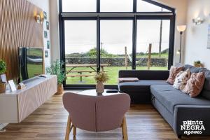a living room with a couch and a table at Photography House by PontaNegraAzores in Altares