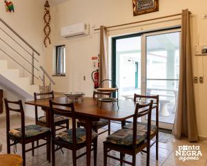 a dining room with a wooden table and chairs at Casa Martins by PontaNegraAzores in Biscoitos
