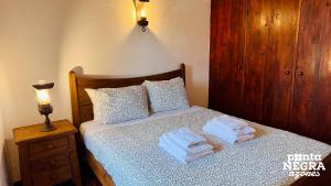 a bedroom with a bed with towels on it at Casa das Vaquinhas by Ponta Negra Azores in Altares +24 photos