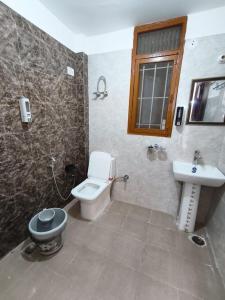 a bathroom with a toilet and a sink at Budget stays in New Delhi