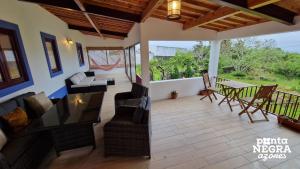 a living room with a couch and chairs and a table at The North House by Ponta Negra Azores in Biscoitos