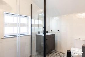 a bathroom with a shower and a toilet and a sink at The Biscuit House by PontaNegraAzores in Praia da Vitória +37 photos