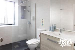 a bathroom with a toilet and a sink and a shower at Casa da Gente by PontaNegraAzores in Biscoitos +54 photos