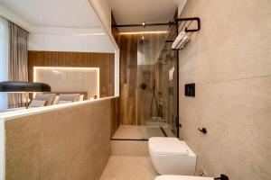a bathroom with a toilet and a shower at MAMALU - Studios and Suites in Naples +44 photos