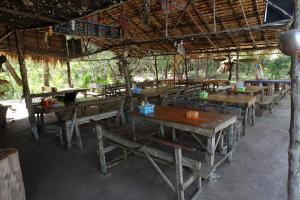 a group of tables and benches in a pavilion at Mr. Chuoi Bar and Hut in Ko Phra Thong