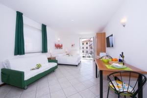 a living room with two couches and a table at Residence Riva del Lario in Gravedona