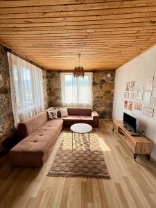 a living room with a couch and a table at Olympos Stone House in Kumluca