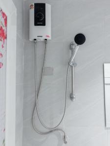 a blow dryer is attached to a wall in a bathroom at On The Six Studios Pratamnak in Pattaya South +86 photos
