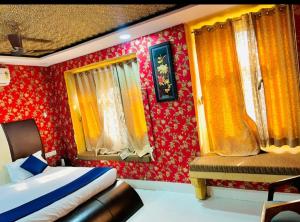 a bedroom with red and yellow walls and a bed at Hostel stay bless in Jaisalmer
