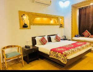 a bedroom with a large bed and a chair at Hostel stay bless in Jaisalmer