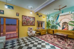 a living room with yellow walls and a checkered floor at Hostel stay bless in Jaisalmer +1 photo