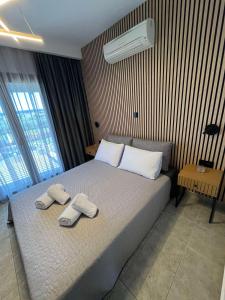 a bedroom with a bed with two towels on it at Domus Afitos in Afitos +17 photos