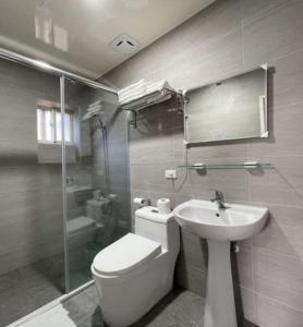 a bathroom with a toilet and a sink and a shower at Xiayun in Fuxing