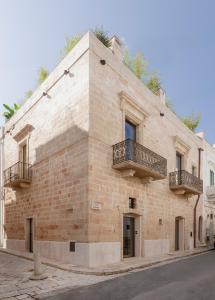 a large brick building with two balconies on it at Palazzo Cerere Boutique Hotel in Polignano a Mare