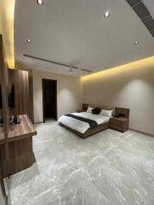 a bedroom with a large bed in a room at ANANTYA BANQUET and HOTEL in Sonīpat