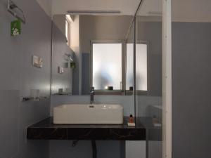 a bathroom with a white sink and a mirror at White Lodge in Kandy +110 photos
