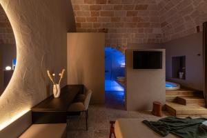 a room with a bathroom with a sink and a toilet at Palazzo Cerere Boutique Hotel in Polignano a Mare +33 photos