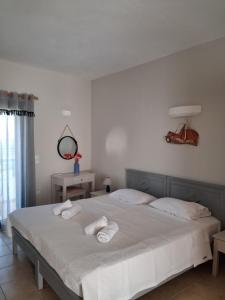 a bedroom with a large bed with towels on it at Elia Studios in Palekastron +50 photos