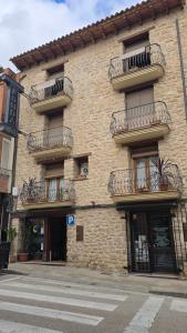a brick building with balconies on the side of it at Fonda Angeleta in Valderrobres