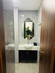 a person taking a picture of a bathroom sink at Green Park Lang Son Apartment in Lạng Sơn +2 photos